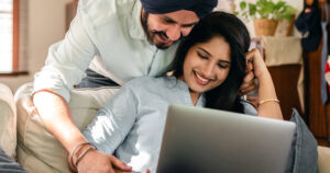 Photo of a Sikh couple looking at computer for possible egg donors.